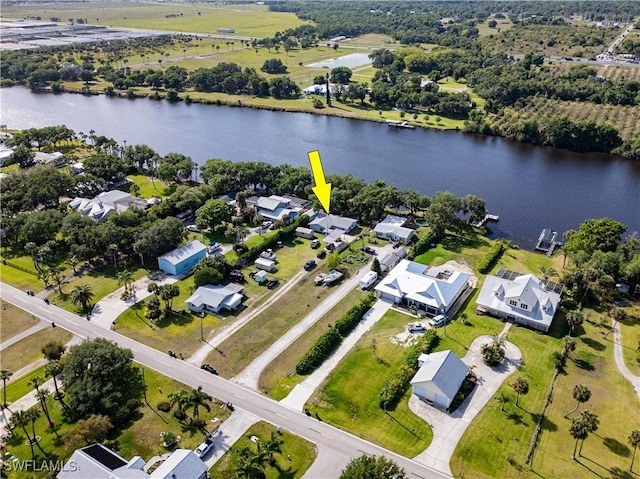 drone / aerial view with a water view and a residential view