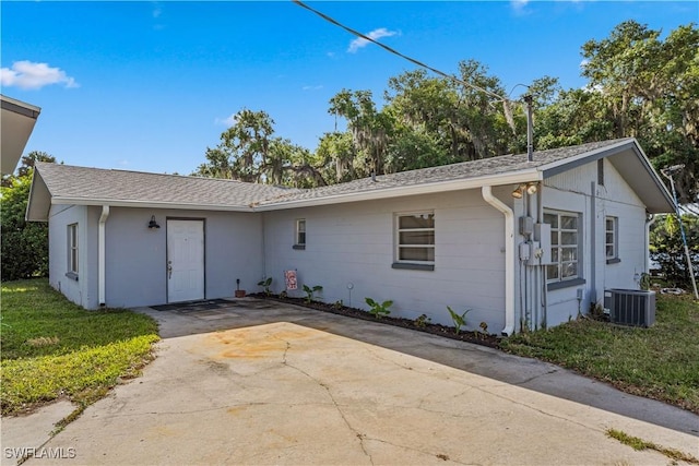 ranch-style home with a patio, central AC, and concrete driveway