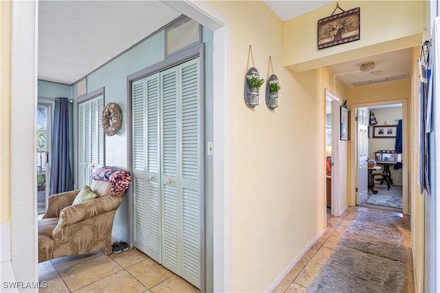 hallway featuring light tile patterned floors