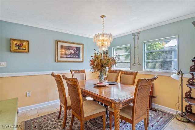 dining room with an inviting chandelier, baseboards, crown molding, and light tile patterned floors