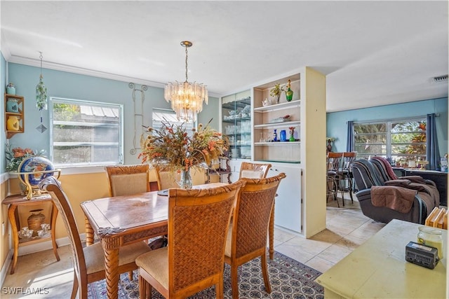 dining area featuring light tile patterned flooring, a chandelier, and a healthy amount of sunlight