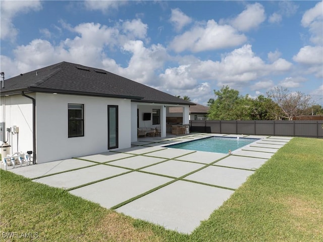 view of swimming pool with a yard, a patio, fence, and a fenced in pool