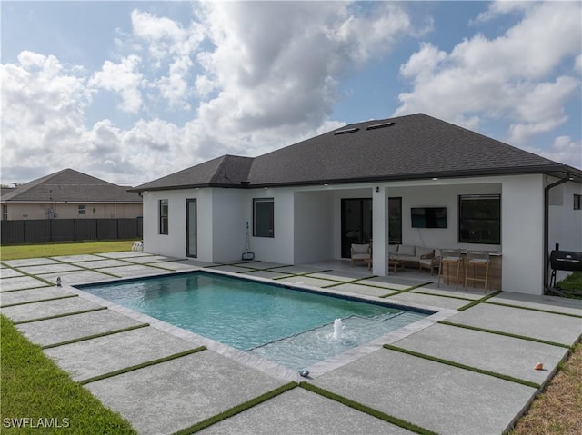 back of house with a patio, roof with shingles, stucco siding, an outdoor living space, and a fenced in pool