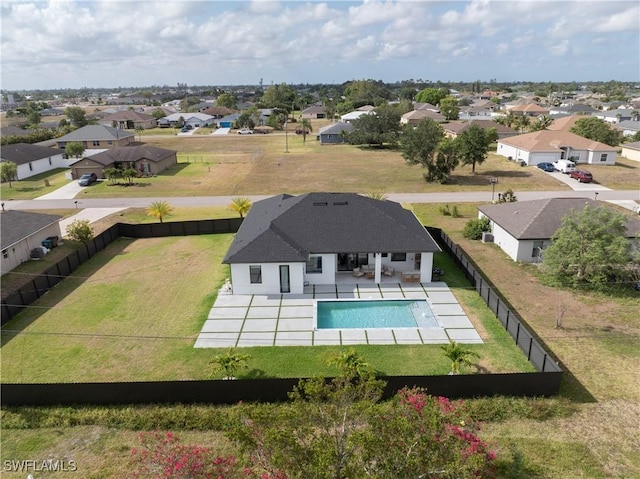 view of pool featuring a residential view, a fenced in pool, a fenced backyard, a patio area, and a lawn