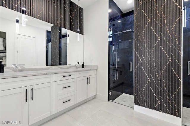 full bathroom featuring double vanity, baseboards, a stall shower, and marble finish floor
