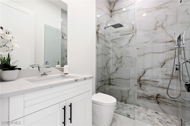 full bath with a marble finish shower, vanity, toilet, and marble finish floor