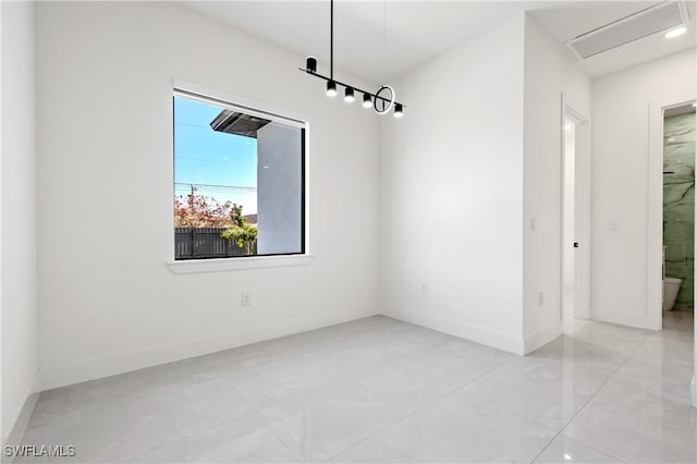 unfurnished dining area featuring baseboards