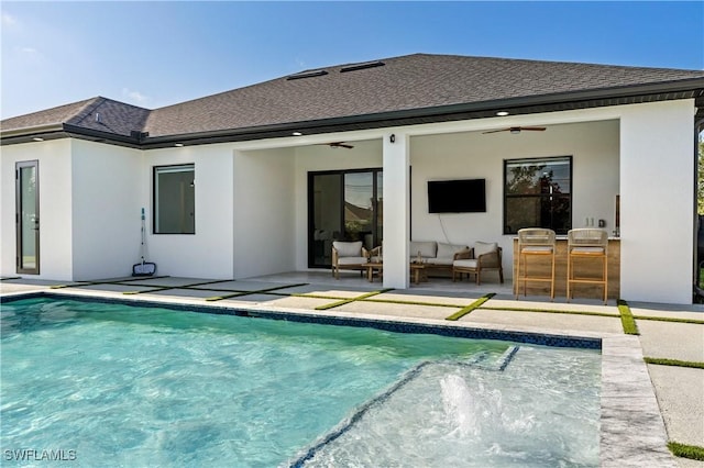 rear view of house featuring ceiling fan, an outdoor living space, an outdoor pool, a patio, and a shingled roof
