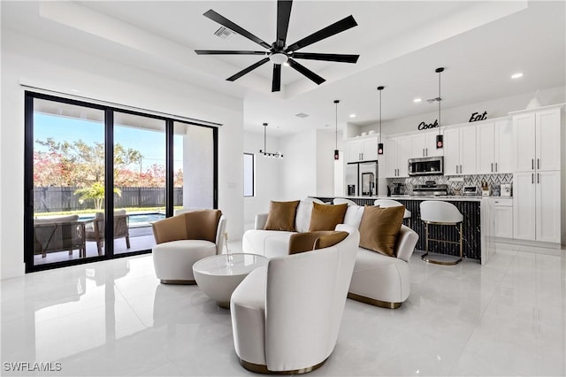 living area with recessed lighting, a ceiling fan, light tile patterned flooring, and a healthy amount of sunlight