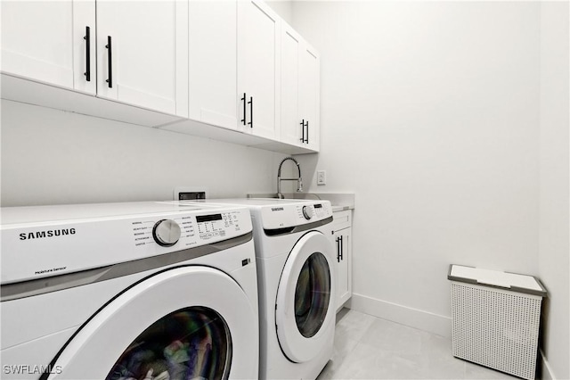 laundry room with cabinet space, a sink, separate washer and dryer, marble finish floor, and baseboards