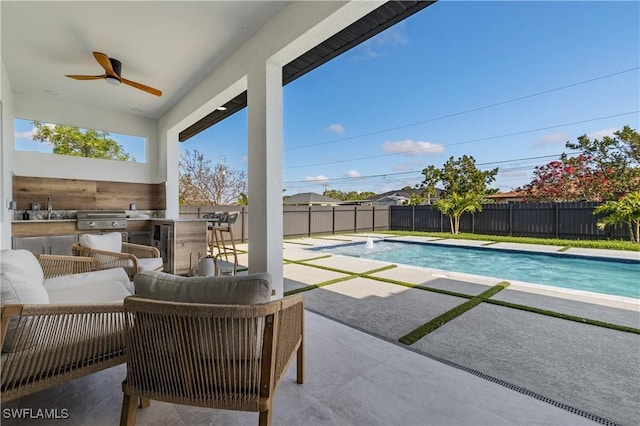 view of swimming pool featuring area for grilling, ceiling fan, a fenced in pool, a fenced backyard, and a patio