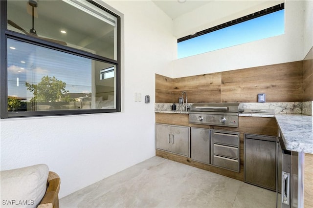 view of patio with a sink, area for grilling, and a grill