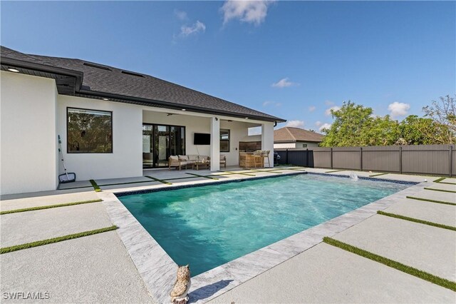 view of swimming pool featuring a fenced in pool, a patio area, fence, and an outdoor hangout area