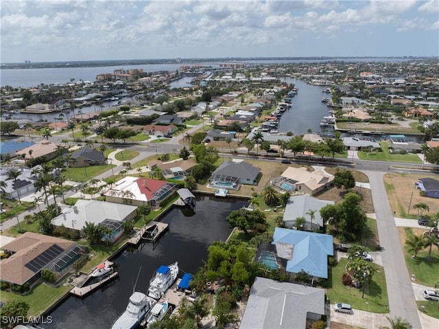 birds eye view of property with a water view and a residential view