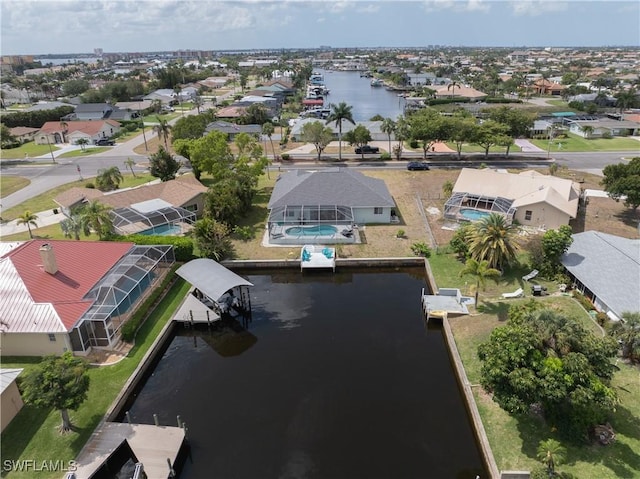 drone / aerial view featuring a water view and a residential view
