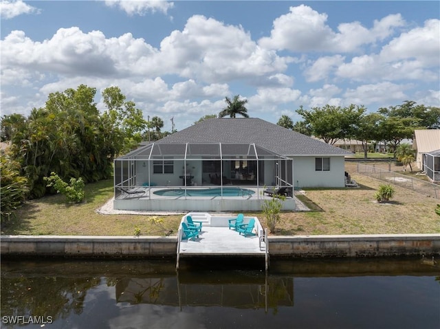rear view of property with a lawn, a patio, a water view, and an outdoor pool