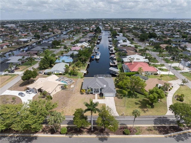 drone / aerial view with a water view and a residential view
