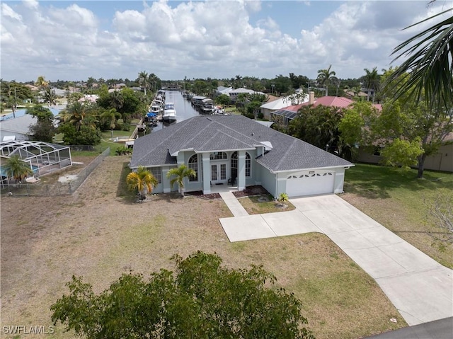 view of front of home featuring a shingled roof, a front lawn, a garage, concrete driveway, and french doors
