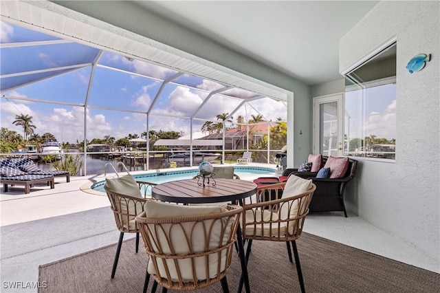 view of patio / terrace with glass enclosure and an outdoor pool