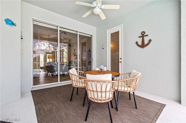 dining room featuring a textured wall and a ceiling fan