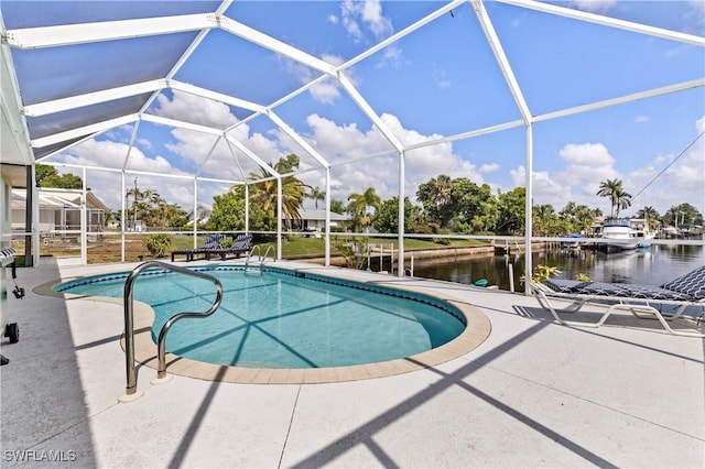 pool with a patio, a water view, and glass enclosure