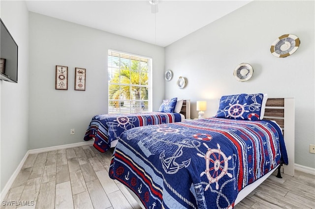 bedroom with baseboards and wood finished floors