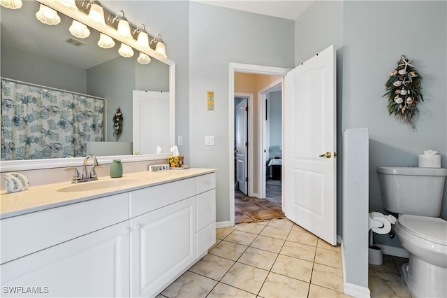 bathroom with visible vents, tile patterned flooring, vanity, baseboards, and toilet