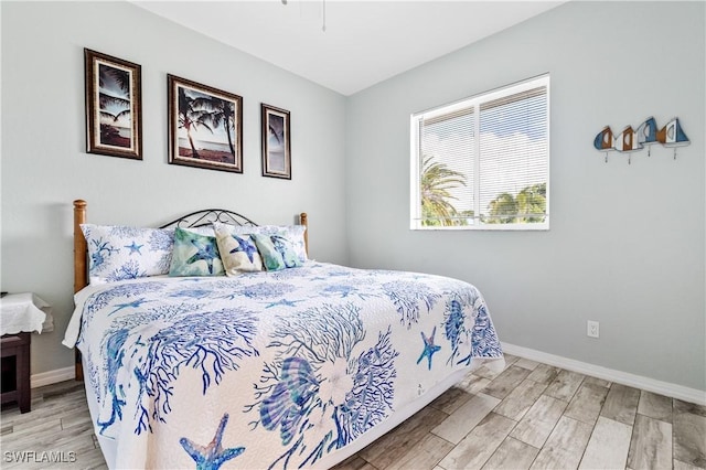 bedroom featuring baseboards and wood finished floors