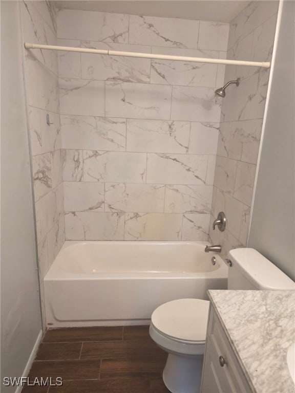 2123 NE 6th Pl, Cape Coral, FL 33909 - bathroom with wood finished floors, shower / washtub combination, vanity, baseboards, and toilet