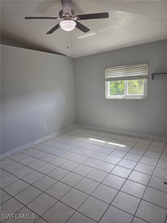 2123 NE 6th Pl, Cape Coral, FL 33909 - empty room featuring light tile patterned floors, ceiling fan, and baseboards