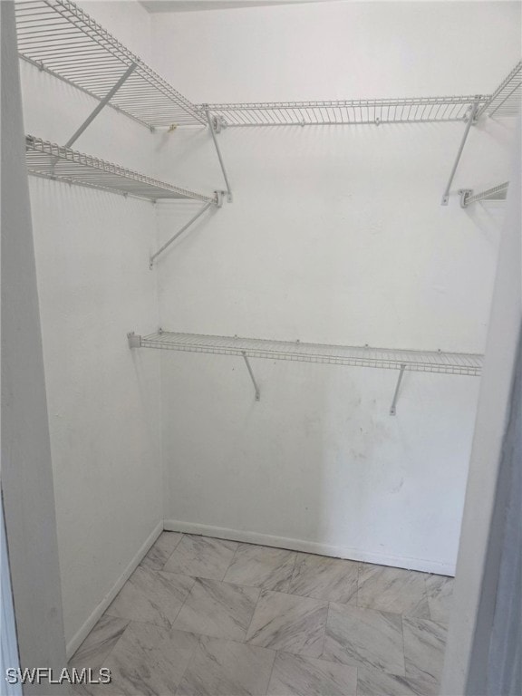 2123 NE 6th Pl, Cape Coral, FL 33909 - walk in closet featuring marble finish floor