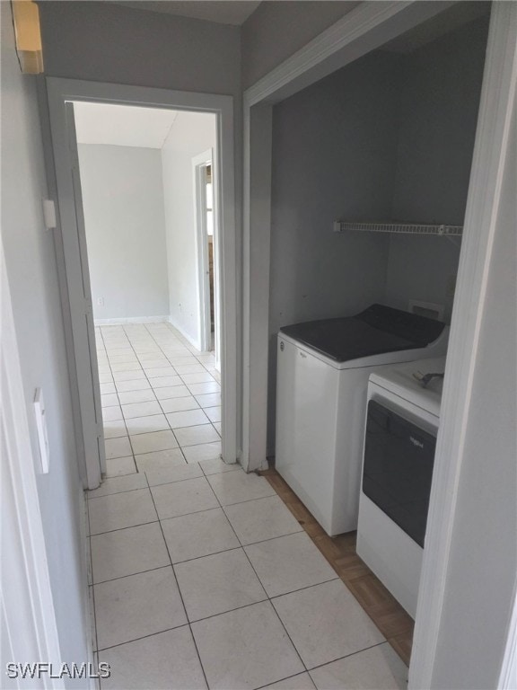 2123 NE 6th Pl, Cape Coral, FL 33909 - clothes washing area with independent washer and dryer, light tile patterned flooring, and laundry area