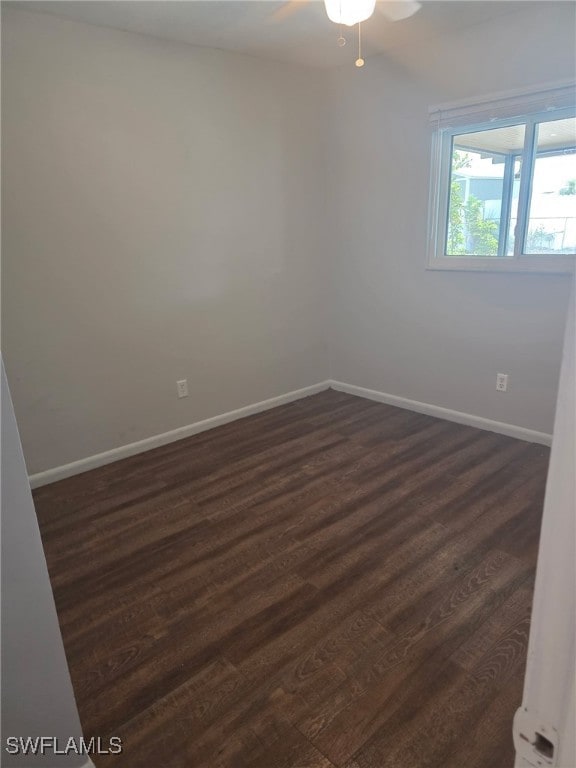 2123 NE 6th Pl, Cape Coral, FL 33909 - spare room with a ceiling fan, baseboards, and dark wood finished floors
