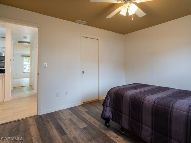 1228 SE 24th Ave Unit A, Cape Coral, FL 33990 - bedroom with wood finished floors, baseboards, and ceiling fan
