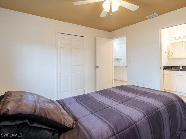 1228 SE 24th Ave Unit A, Cape Coral, FL 33990 - bedroom featuring a closet, a ceiling fan, a sink, and ensuite bath