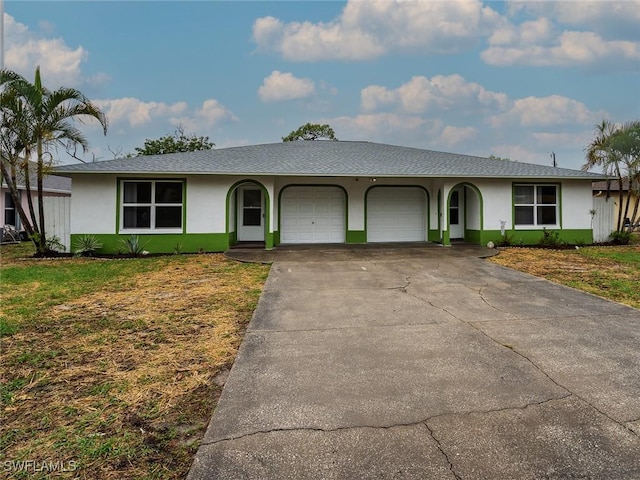 1228 SE 24th Ave Unit A, Cape Coral, FL 33990 - single story home featuring an attached garage, stucco siding, a front lawn, and concrete driveway