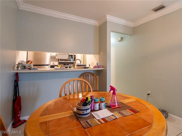 1228 SE 24th Ave Unit A, Cape Coral, FL 33990 - dining area with crown molding, tile patterned floors, and baseboards