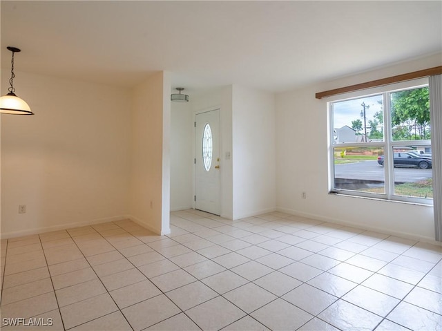 1228 SE 24th Ave Unit A, Cape Coral, FL 33990 - empty room with healthy amount of natural light, light tile patterned floors, and baseboards