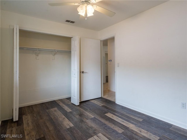 1228 SE 24th Ave Unit A, Cape Coral, FL 33990 - unfurnished bedroom featuring dark wood finished floors, a closet, baseboards, and a ceiling fan