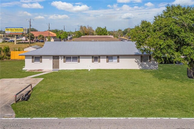 12955 First St, Fort Myers, FL 33905 - single story home with a front yard and metal roof