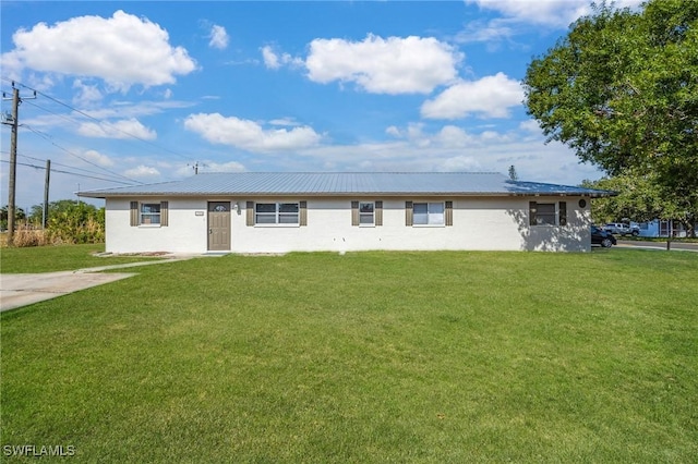 12955 First St, Fort Myers, FL 33905 - single story home with stucco siding, metal roof, and a front lawn