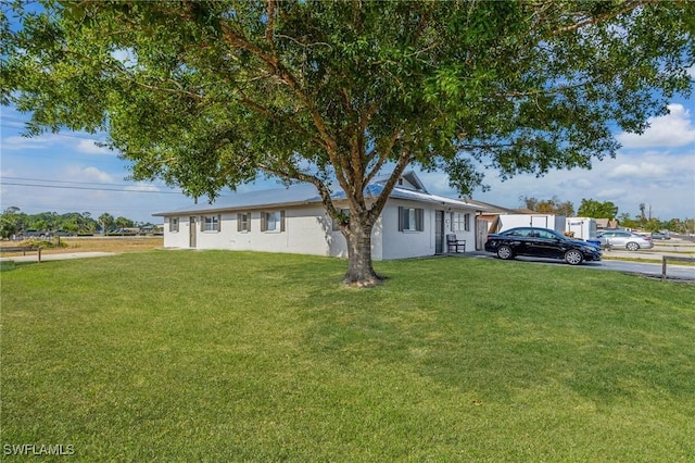 12955 First St, Fort Myers, FL 33905 - ranch-style house with stucco siding and a front yard