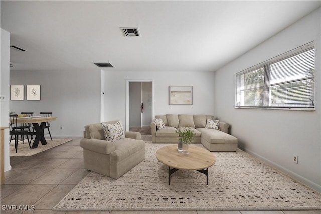 12955 First St, Fort Myers, FL 33905 - tiled living room featuring visible vents and baseboards