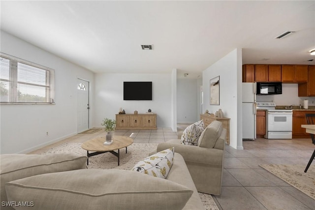 12955 First St, Fort Myers, FL 33905 - living room featuring light tile patterned flooring, baseboards, and visible vents
