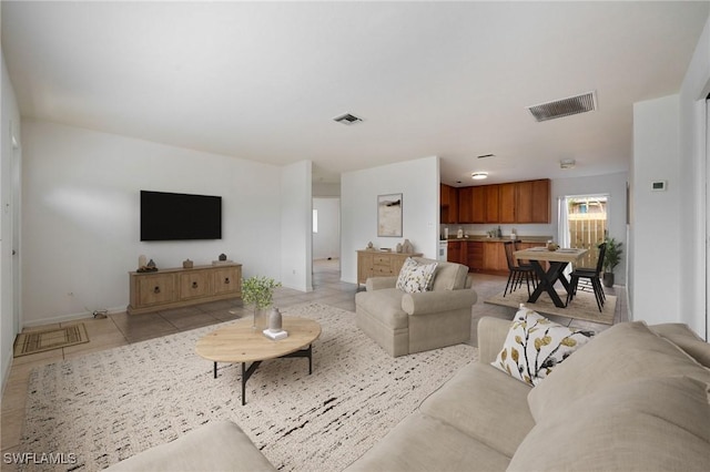 12955 First St, Fort Myers, FL 33905 - living room featuring light tile patterned floors, baseboards, and visible vents