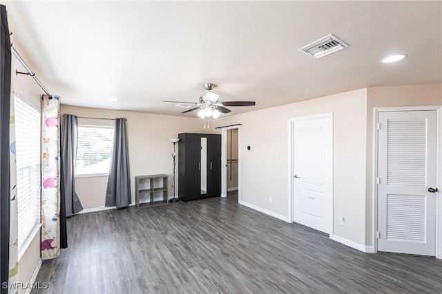 unfurnished living room with baseboards, a ceiling fan, wood finished floors, and visible vents