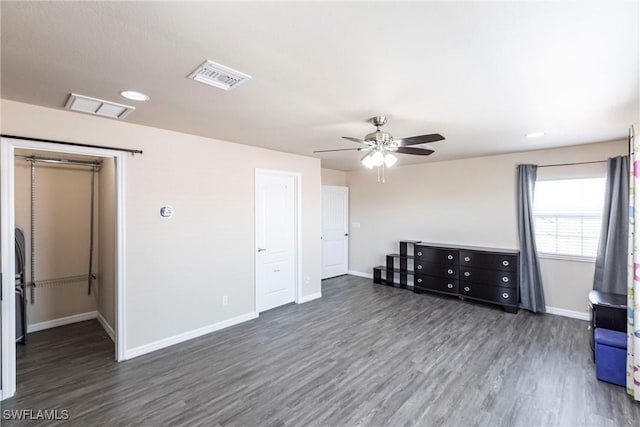 empty room with baseboards, visible vents, and wood finished floors