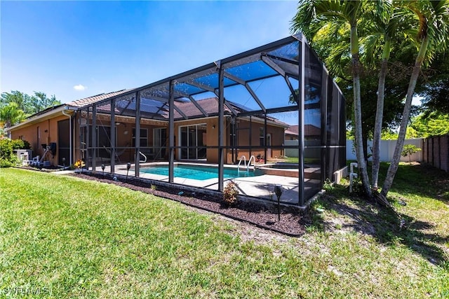 view of swimming pool with fence, a fenced in pool, a jacuzzi, glass enclosure, and a yard