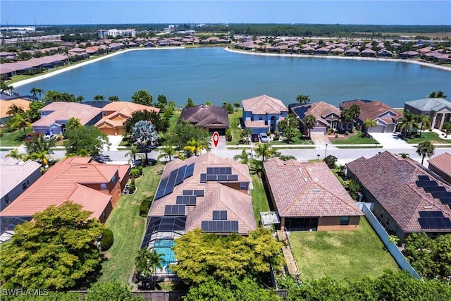 birds eye view of property with a water view and a residential view