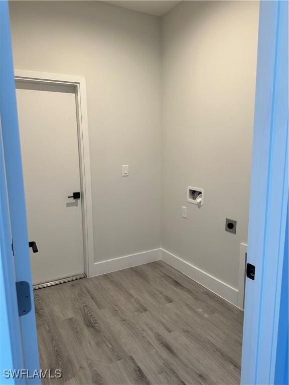 laundry area with laundry area, wood finished floors, baseboards, hookup for a washing machine, and electric dryer hookup